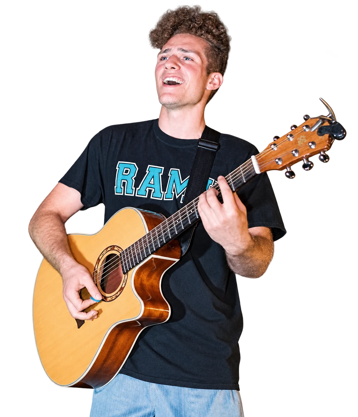 Rami singing and playing acoustic guitar